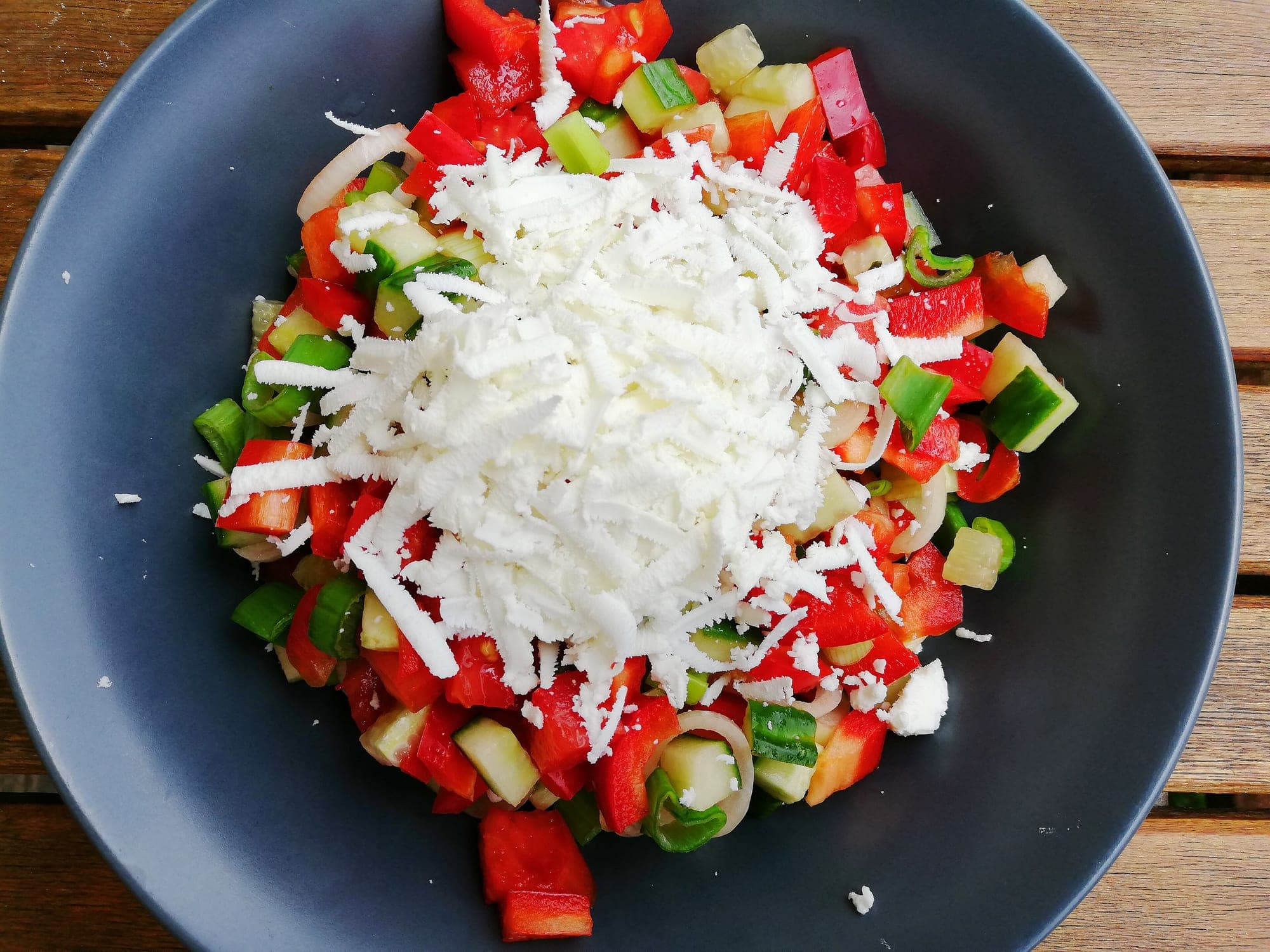 Shopska salad of diced tomato, cucumber and pepper topped with finely grated white cheese
